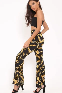 Rebellious Fashion Black Gold Chain Print Flared Trousers - Brooke